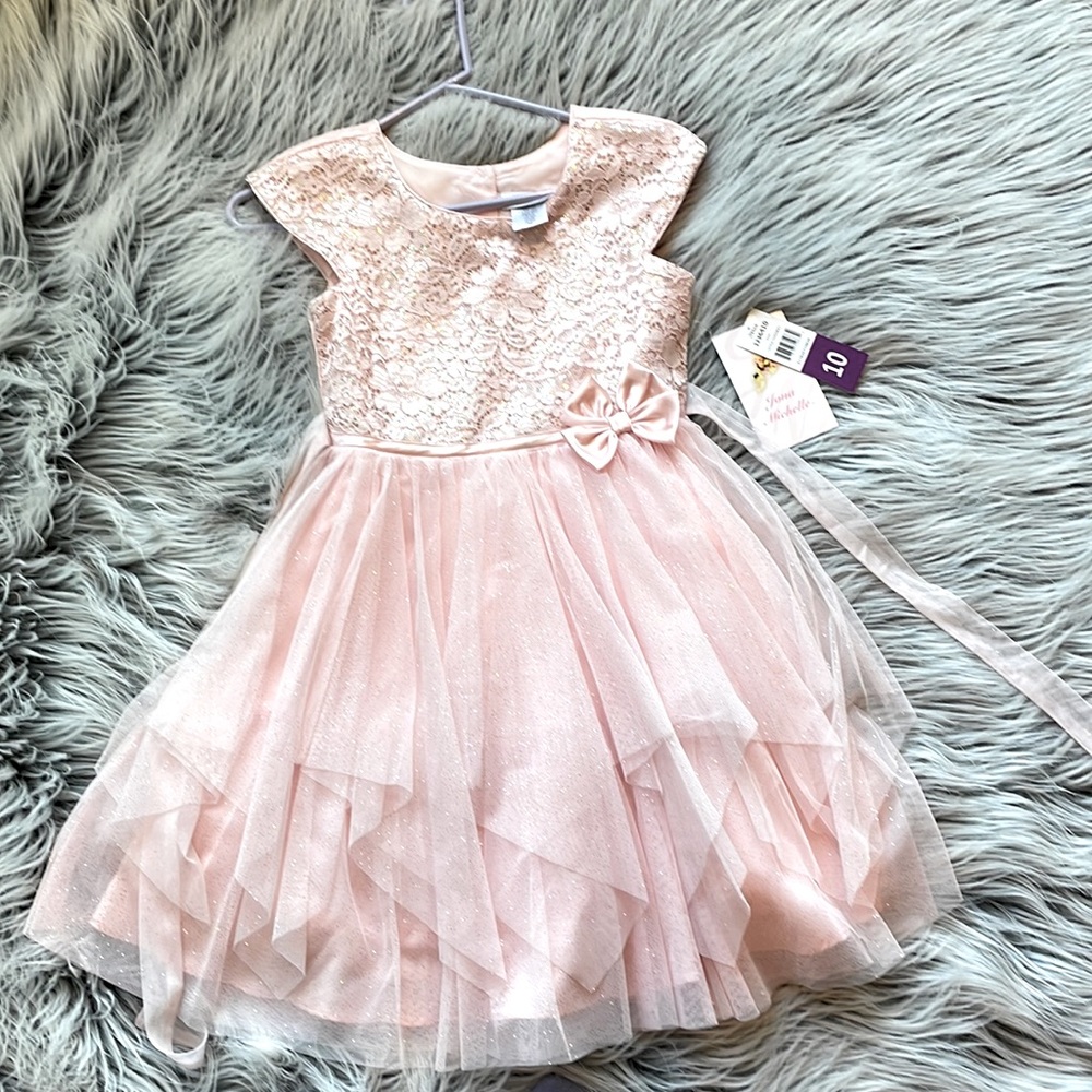 Jona Michelle girls dress in size 10, never worn. Sparkly with ruffle details.